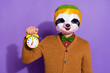 Photo of weird sloth mask person hand hold retro bell isolated on purple color background