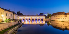 France, Bas-Rhin, Strasbourg, Long Exposure Of Ill River Canal At Dusk With Barrage Vaubanbridge In Background