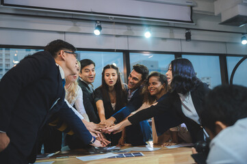 Wall Mural - young business people putting their hands together. Stack of hands. Unity and teamwork concept.