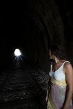 SriLanka,UvaProvince, Demodara, Adult Woman Looking Over Shoulder At Light At End Of Tunnel