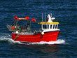 Small fishing boat underway at sea to fishing grounds.