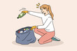 Ecology and environment saving concept. Smiling girl sitting and picking up collecting garbage trash to bag in gloves taking care of ecological situation vector illustration 