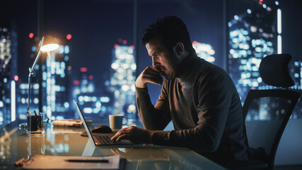 Poster - Portrait of Thoughtful Successful Businessman Working on Laptop Computer in His Big City Office at Night. Energetic Digital Entrepreneur does Data Analysis for e-Commerce Strategy.