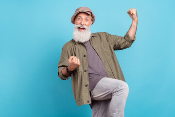 Sticker - Photo of celebrate grey beard elder man hands fists yell wear peaky blinder khaki shirt isolated on blue color background