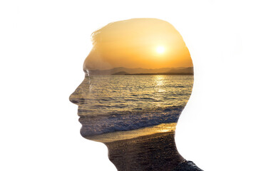 Wall Mural - Combination of the silhouette of a man face and a seascape with a sunset. Concept of unity of nature and people