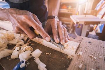 Carpenter working with equipment on wooden table in carpentry shop. men works in a carpentry shop.