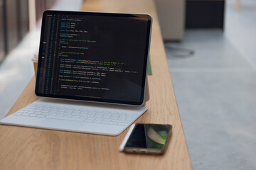 Wall Mural - freelancer's workplace. a thin mobile laptop on a table in a coworking or other public space. low de