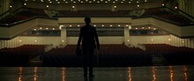 WIDE Young Aspiring Musician Violin Player Entering Stage Of A Huge Concert Hall As Lights Changing From Ambient To Stage. Shot With 2x Anamorphic Lens