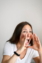 Mature Woman Shouting Against White Background