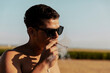 © Westend61 - Young man with eyeglasses smoking marijuana joint