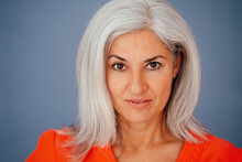 Businesswoman With White Hair Over Gray Background