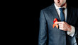 Hiv aids. Red ribbon in hiv world day isolated on dark background. Man holding awareness aids and cancer symbol. Health, Medical sign. copy space.