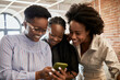 © Westend61 - Female entrepreneurs looking at smart phone at coworking office