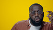 © stockbusters - Portrait of african american man dancing on yellow background. Guy having fun