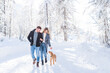 © Westend61 - Boyfriend and girlfriend walking on snow with dog during vacation