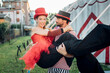 © Westend61 - Male acrobat carrying female performer while standing outside circus tent