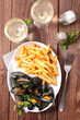 mussel and french fries with glasses of wine