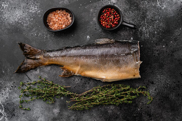 Wall Mural - Whole hot smoked fish, on black dark stone table background, top view flat lay