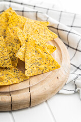 Wall Mural - Salted tortilla chips triangle with chia seeds.