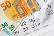© LariBat - European power plug Type C and euro banknotes on calendar background. Concept of payment of accounts, tariff increase