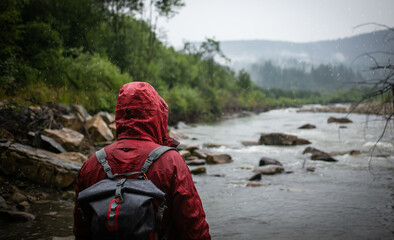 Wall Mural - Angler near a mountain river on a rainy day. Fishing background. 