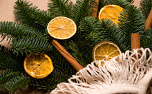 Mock Up Of Spruce Branches Decorated With Citrus And Cinnamon Sticks.Natural Decarations For Fir Tree. Eco Friendly And Zero Waste Concept.Winter Holidays