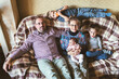 © Lea Csontos/Stocksy - Family sitting and relaxing on a couch