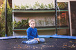 © Lea Csontos/Stocksy - Young boy sitting on a trampoline and cry