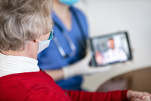 Health: Nurse Shows Senior Telehealth On Tablet