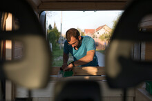 Man Working On Fixing Hi Camper Van