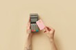 © Yaroslav Danylchenko/Stocksy - Woman making transaction with card