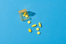 Dose Pill Box With Medical Pills On Blue Background.