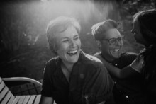 B/W Laughing Lesbian Parents With Daughter