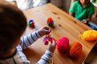 © Valentina Barreto/Stocksy - Children making crafts with wool