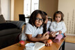 © Valentina Barreto/Stocksy - Children eating apples at home