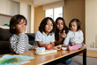 © Valentina Barreto/Stocksy - Children eating snack at home