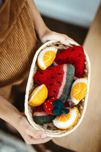 Kid Holding A Felt Wool Fruit Toys Basket