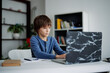 © Oleksii Syrotkin/Stocksy - Young boy using laptop during online education process