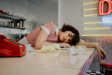 1950s Diner Waitress Laying Over Counter