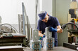 © ALTO IMAGES/Stocksy - Male mechanic repairing plastic bottles molds