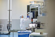 © ALTO IMAGES/Stocksy - Focused employee operating modern industrial machine