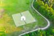 Land Plot for Housing on green field - aerial drone shot. Topographical Marking of two plots of Land for Private Residence House Construction. Land Plot plan with white Graphic House icon.