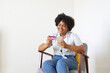 © ALTO IMAGES/Stocksy - Happy woman shopping online