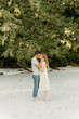 © Luke Liable/Stocksy - Young couple kissig on a beach