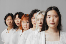 A Group Of Different Asian Women Are Standing In A Row