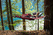 © Stacey Dunn/Stocksy - Woman meditating in hammock in forest