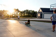 © Jessica Klaus/Stocksy - Sun setting over a driveway.