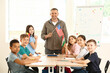 © Pixel-Shot - Children and teacher during lesson at language school
