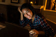 © Manu Prats/Stocksy - Hispanic woman using laptop at home