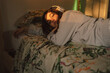 © Eloisa Ramos/Stocksy - Sleepy girl in bed portrait
